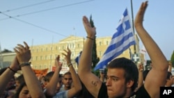 Protesters shout slogans during a rally against the austerity economic measures and corruption, in front of the parliament in Athens' Syntagma [Constitution] in Greece, June 23, 2011