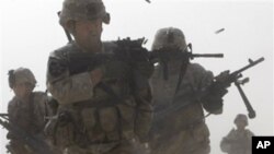 A U.S. soldier returns fire as others run for cover during a firefight with insurgents in the Badula Qulp area, West of Lashkar Gah in Helmand province, southern Afghanistan (FILE).