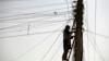 FILE - An Afghan man repairs electricity cables along the streets of Kabul, Nov. 16, 2009. The country is negotiating for an increase in energy supplies from its Central Asian neighbors.