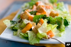 FILE - This Jan. 24, 2012, file photo shows a plate of butternut Caesar salad with Romaine lettuce and roasted cubes of butternut squash. (AP Photo/Matthew Mead, File)