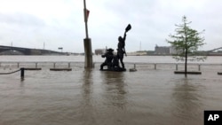 A statue of explorers Lewis and Clark is surrounded by floodwater along the St. Louis riverfront, May 2, 3019. 