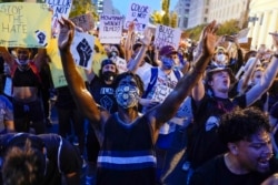 Demonstrators protest, Thursday, June 4, 2020, near the White House in Washington, over the death of George Floyd, a black man who was in police custody in Minneapolis. Floyd died after being restrained by Minneapolis police officers.