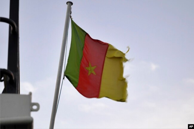 A Cameroonian flag flies on a ship at the port in Douala, Cameroon, on April 10, 2022. (AP Photo/Grace Ekpu)