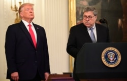FILE - U.S. President Donald Trump and Attorney General William Barr participate in a ceremony in the East Room of the White House in Washington, Sept. 9, 2019.