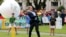 Britain's Prince William hits a ball using a cricket bat while attending a promotional event for the upcoming Cricket World Cup in Christchurch, New Zealand.