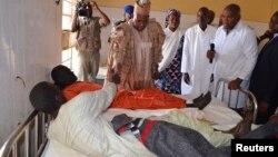 Borno State Governor Kashim Shettima visits injured victims receiving treatment at a hospital following an attack in Kawuri on January 28, 2014.