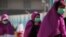 Muslim pilgrims wears surgical masks to help prevent infection from a respiratory virus known as the Middle East Respiratory Syndrome (MERS) in the holy city of Mecca, Saudi Arabia, May 13, 2014.