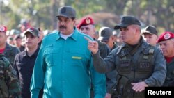 Venezuelan President Nicolas Maduro speaks with senior military officials during a military exercise in Valencia, Venezuela, Jan. 27, 2019.