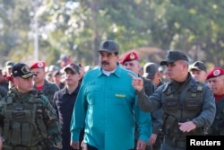 Venezuelan President Nicolas Maduro speaks with senior military officials during a military exercise in Valencia, Venezuela, Jan. 27, 2019.