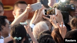 Indian Prime Minister Narendra Modi takes a selfie using a cell phone.