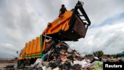 FILE - A person works in a landfill in Phuket, Thailand, Nov. 22, 2024. 