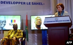 French Defense Minister Florence Parly, right, delivers a speech next to Burkina Faso's President Roch Marc Christian Kabore, during a G5 Sahel summit in Niamey, Niger on Feb. 6, 2018.