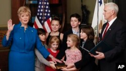 Vice President Mike Pence swears in Small Business Administrator Linda McMahon, joined by her six grandchildren, in the Eisenhower Executive Office Building on the White House complex in Washington, Feb. 14, 2017.