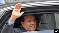 Italy Prime Minister Silvio Berlusconi waves as he leaves the Justice Palace in Milan, Italy, September 19, 2011.