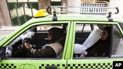 A female taxi driver is seen fetching a passenger in Tehran, Iran, August 21, 2011. About 500 female drivers make up the Women's Taxi company which serves only female passengers. 