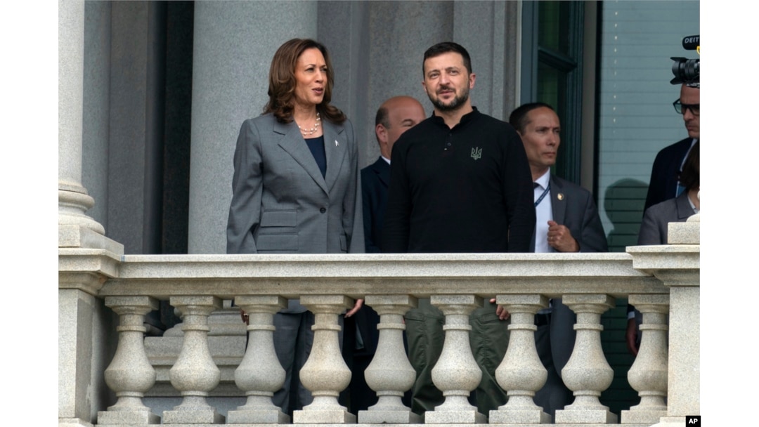 Vice President Kamala Harris and Ukraine's President Volodymyr Zelenskyy converse on the balcony of the Eisenhower Executive Office Building on the White House complex in Washington, Sept. 26, 2024.