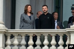 Vice President Kamala Harris and Ukraine's President Volodymyr Zelenskyy converse on the balcony of the Eisenhower Executive Office Building on the White House complex in Washington, Sept. 26, 2024.