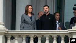 Vice President Kamala Harris and Ukraine's President Volodymyr Zelenskyy converse on the balcony of the Eisenhower Executive Office Building on the White House complex in Washington, Sept. 26, 2024.