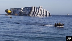 Navy teams conducting rescue efforts are seen January 21, 2012, near the Costa Concordia cruise ship which ran aground off the west coast of Italy at Giglio island.