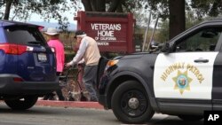 People walk to the information center at the Veterans Home of California in Yountville, Calif., March 9, 2018. A gunman took at least three people hostage at the largest veterans home in the United States on Friday, leading to a lockdown of the sprawling grounds in California, authorities said. 