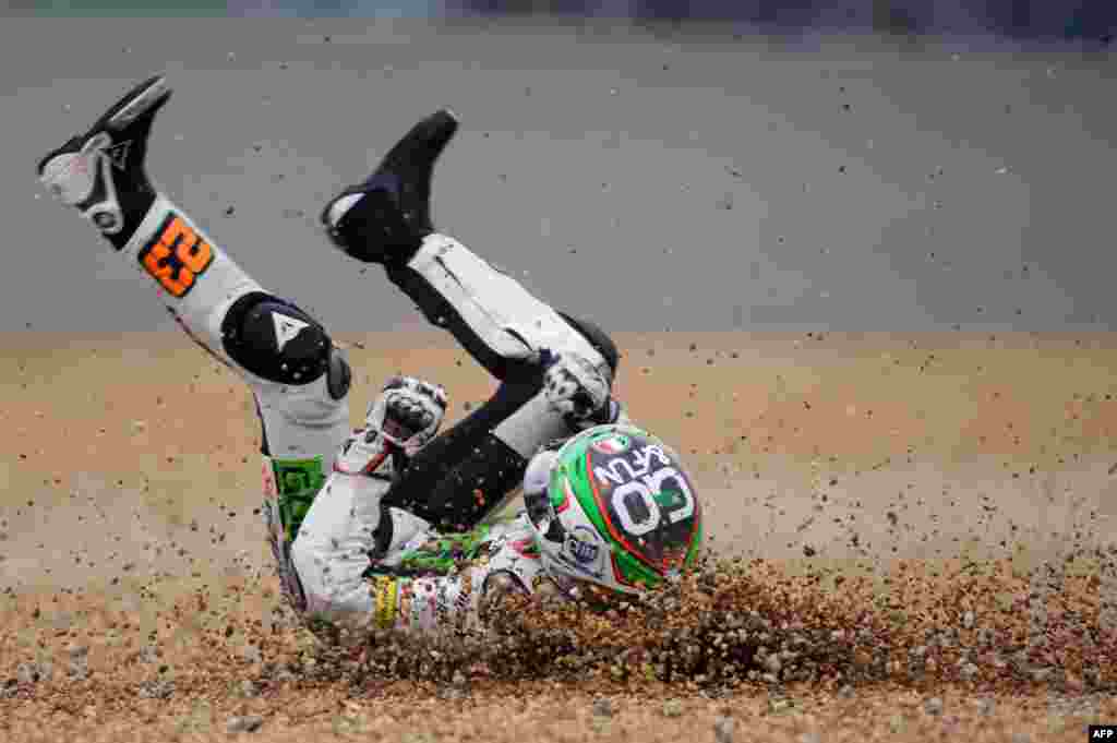Spain&#39;s Niccolo Antonelli glides on the ground after crashing during the Moto 3 race of the French Motorcycling Grand Prix at Le Mans circuit, western France. 