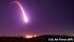 FILE - This image taken with a slow shutter speed shows an unarmed Minuteman 3 intercontinental ballistic missile test launch at Vandenberg Air Force Base, California, Oct. 2, 2019.