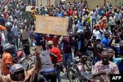 Protesters march with placards as they call for reforms during an anti-government rally in Lome, Togo, Sept. 6, 2017.