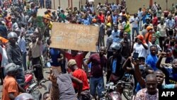 Protesters march with placards as they call for reforms during an anti-government rally in Lome, Togo, Sept. 6, 2017. 