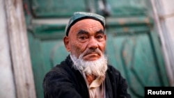FILE - An Uighur man sits at a street market in Kashgar, Xinjiang province.