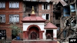 FILE - A small temple structure is seen undamaged amidst rubble of damaged buildings at the heritage town of Bhaktapur on April 29, 2015.