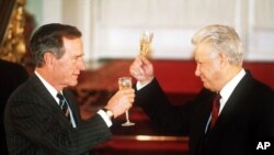 FILE - Then-Russian President Boris Yeltsin toasting with then-U. S. President George H. W. Bush after they signed the START II treaty in Moscow, Jan. 3, 1993.