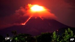 Lava cascades down the slopes of Mayon volcano as seen from Legazpi city, Albay province, around 340 kilometers (210 miles) southeast of Manila, Philippines, Monday, Jan. 15, 2018. 