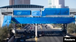 Traffic passes under a monorail station covered by an advertisement from Intel for the 2014 Consumer Electronics (REUTERS/Steve Marcus) 