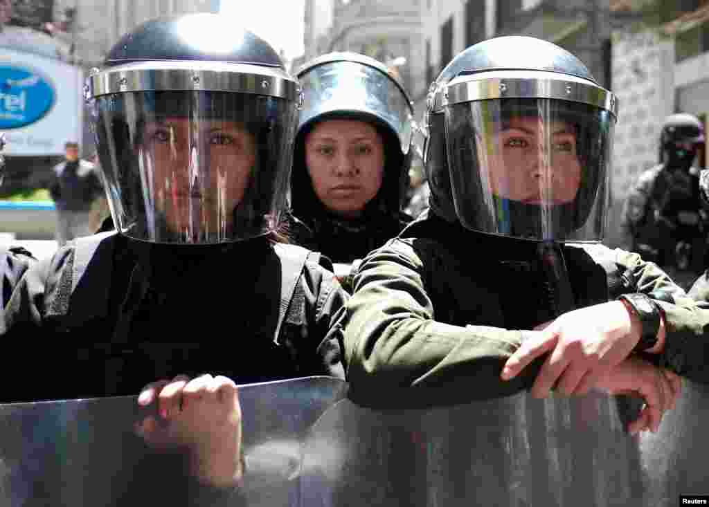 Riot policewomen stand guard next to the vice presidency building during a rally on International Women&#39;s Day, in La Paz, Bolivia.