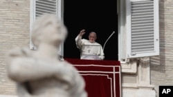 Pope Francis waves to faithful during the Angelus noon prayer in St. Peter's Square, at the Vatican, Sunday, Dec. 16, 2018.