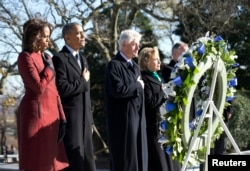 President Barack Obama (2nd L), first lady Michelle Obama (L), former President Bill Clinton (3rd L) and Hillary Clinton participate in a wreath laying in honor of assassinated President John F. Kennedy at Arlington National Cemetery, near Washington, D.C., Nov. 20, 2013.