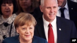  German Chancellor Angela Merkel and United States Vice President Mike Pence arrive at the Munich Security Conference in Munich, Germany, Feb. 18, 2017. 