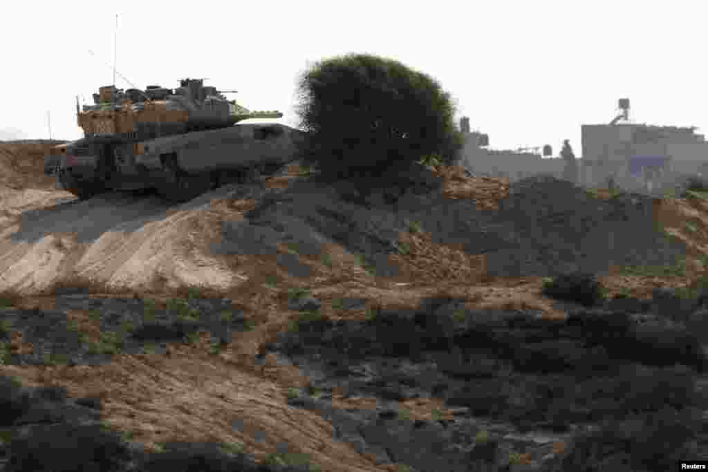 An Israeli tank patrols outside the border with the northern Gaza Strip, October 24, 2012. 