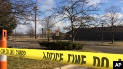 Police tape surrounds the area of a random shooting on Sunday in Kalamazoo, Mich., Feb. 21, 2016.