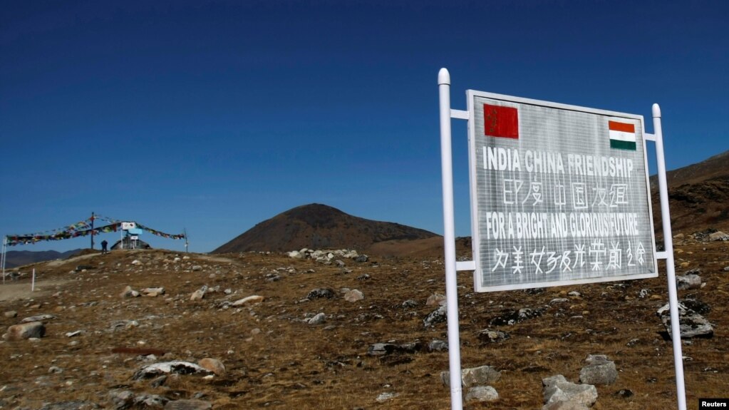 FILE - A signboard is seen from the Indian side of the Indo-China border at Bumla, in the northeastern Indian state of Arunachal Pradesh, Nov. 11, 2009.