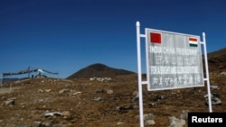 FILE - A signboard is seen from the Indian side of the Indo-China border at Bumla, in the northeastern Indian state of Arunachal Pradesh, Nov. 11, 2009. 