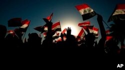 Followers of a political movement called the Al-Fateh Alliance chant during a rally before the parliamentary elections in Baghdad, Iraq, Oct. 7, 2021.