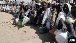 FILE - Internally displaced persons wait to be served with food at Dikwa camp, in northeast Nigeria's Borno state, Feb. 2, 2016.