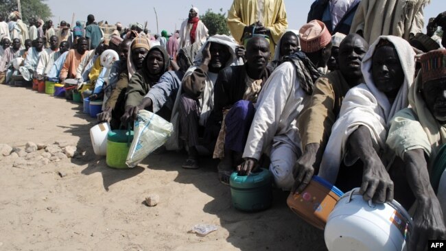 FILE - Internally displaced persons wait to be served with food at Dikwa camp, in northeast Nigeria's Borno state, Feb. 2, 2016. More than 5.1 million people are severely food insecure in parts of Borno, Adamawa and Yobe states in northeastern Nigeria.