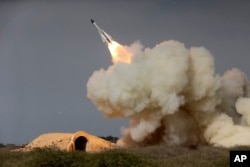 FILE - A long-range S-200 missile is fired in a military drill in the port city of Bushehr, on the northern coast of Persian Gulf, Iran, Dec. 29, 2016.