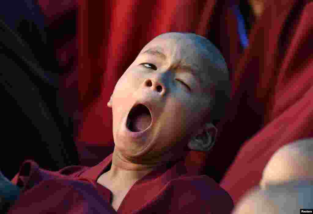 A novice monk yawns as he attends teachings by Tibetan spiritual leader the Dalai Lama in Bomdila in the northeastern state of Arunachal Pradesh, India.