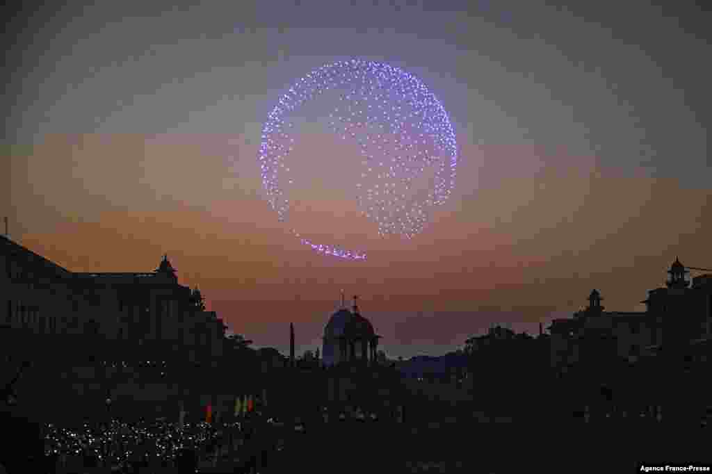 Spectators use their mobile phones as drones with lights fly over the Presidental Palace during the &#39;Beating Retreat&#39; ceremony in New Delhi, India, Jan. 29, 2022.