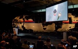 A video shows the impact of a missile on Malaysia Airline Flight 17 during a press conference in Gilze-Rijen, the Netherlands, Oct. 13, 2015.