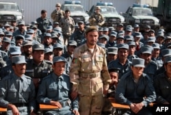 FILE - Afghan General Abdul Raziq (C), police chief of Kandahar, poses for a picture during a graduation ceremony at a police training center in Kandahar province, Afghanistan, Feb. 19, 2017.