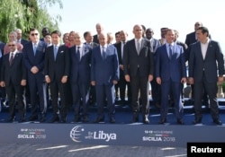 Heads of delegations pose for a photo during the second day of the international conference on Libya in Palermo, Italy, Nov. 13, 2018.